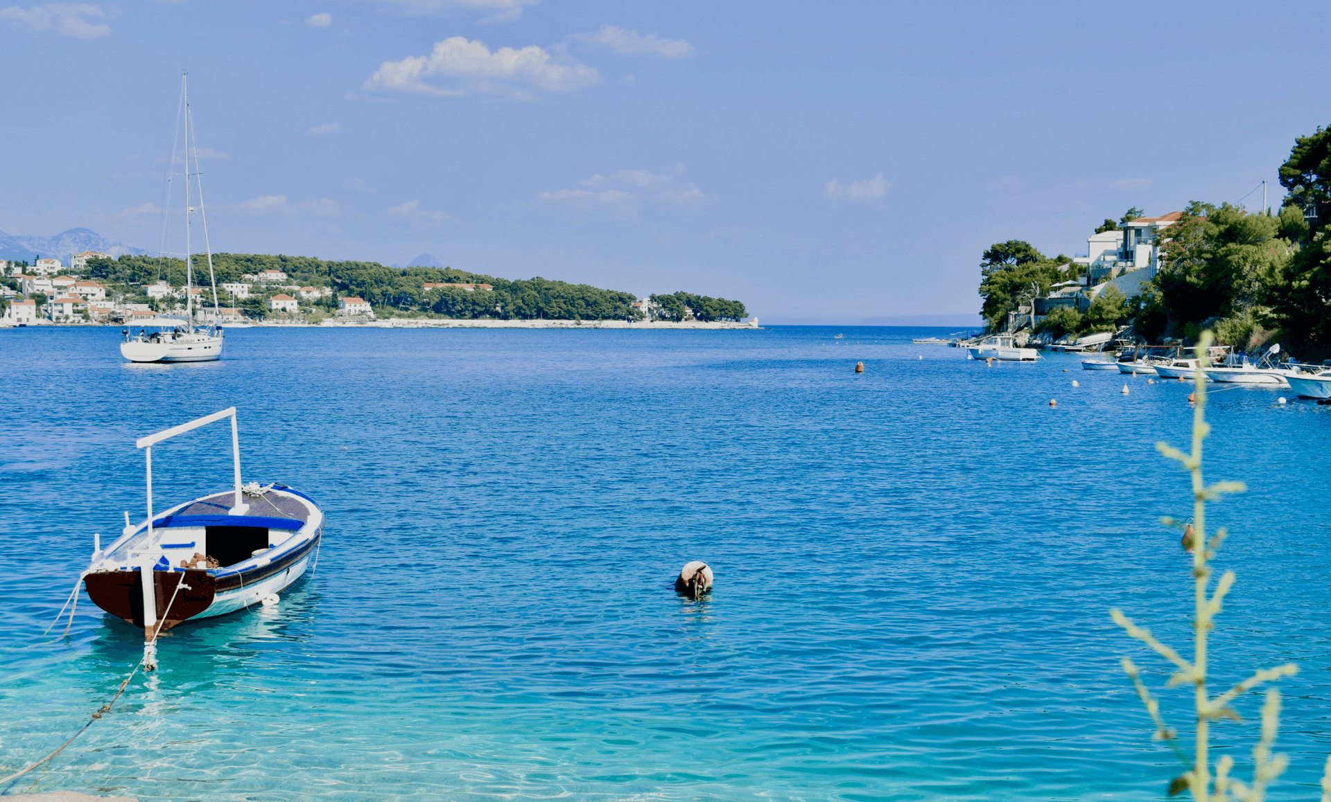 Small boat floating on the Adriatic Sea along the coast of Croatia, honoring the Croatian heritage of SPM Santa Paula Materials and their use of Croatian limestone.