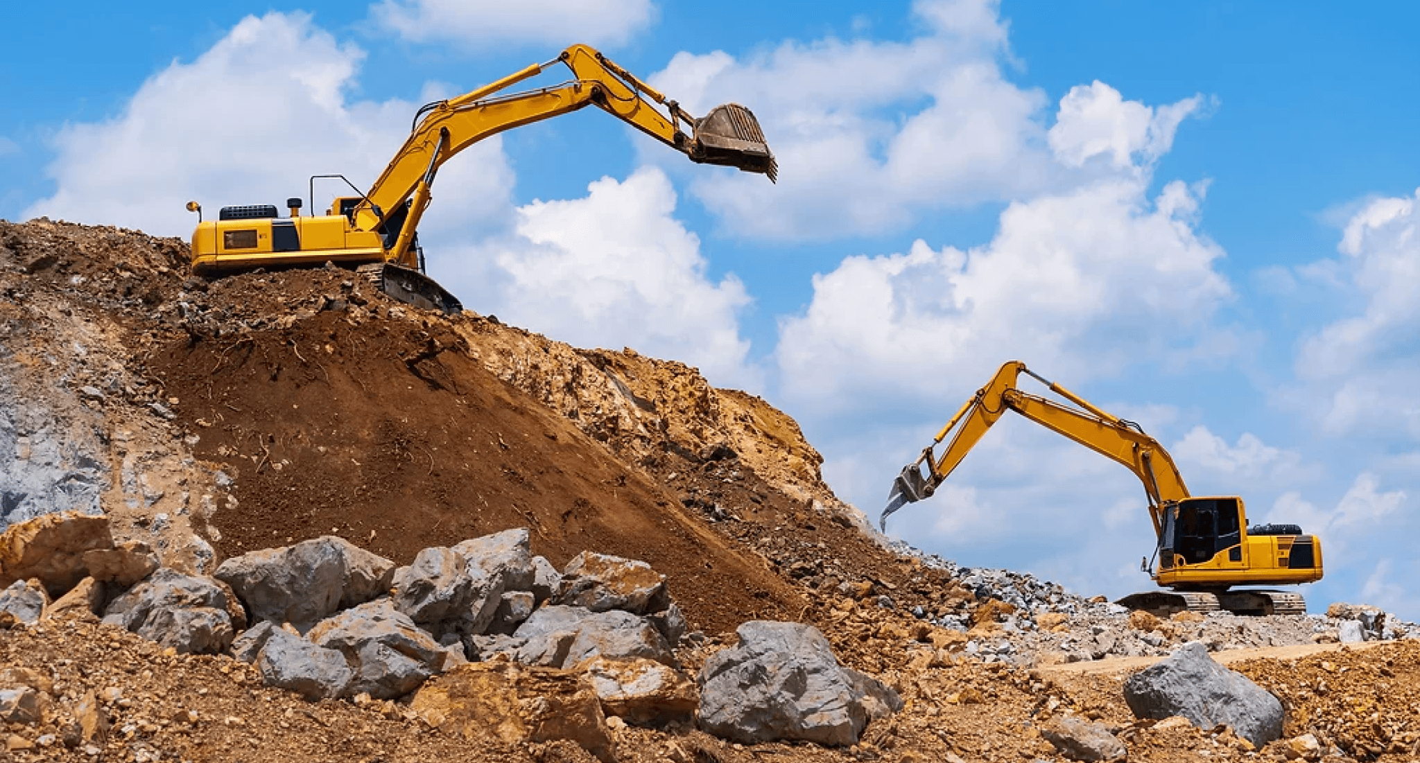 Recycled rock materials being moved by heavy equipment at MRC Rock & Sand’s processing yard